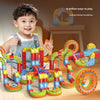 A young boy is playing with a colorful magnetic anti-gravity train track set featuring glowing rails and various track pieces