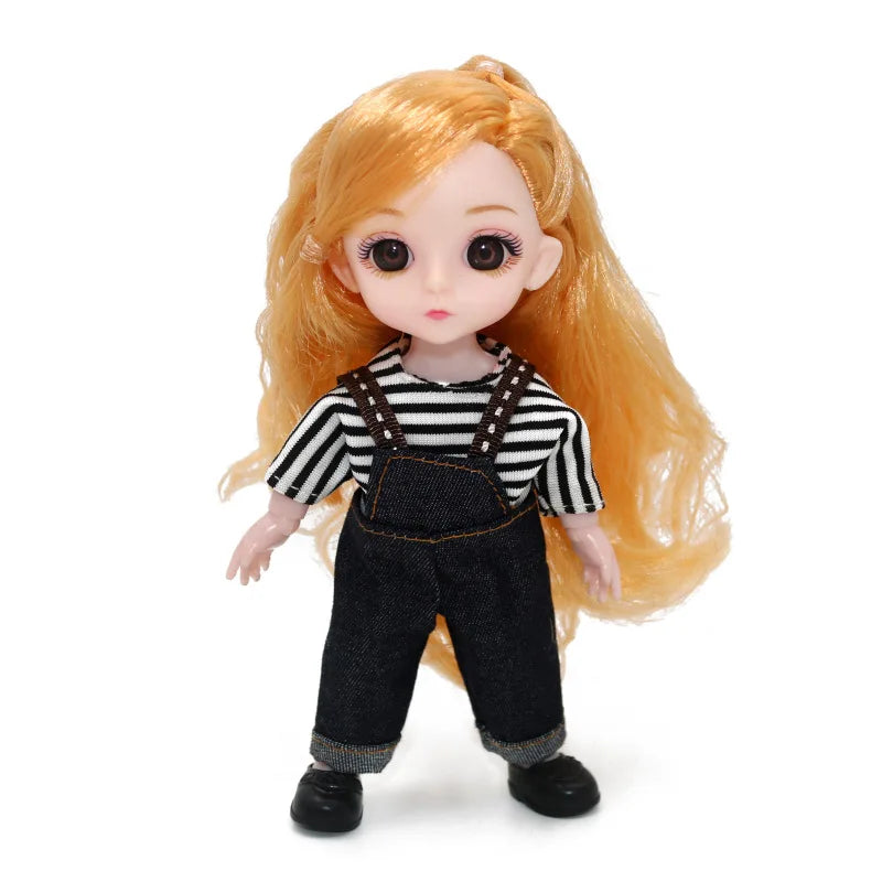 An orange-haired Articulated BJD princess doll wearing a black and white striped top and denim overalls.