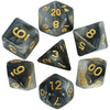 A set of black polyhedral dice showing various numbers with a cosmic or glitter effect.