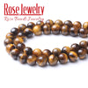 A string of polished, natural yellow tiger eye stone beads used for jewelry making.