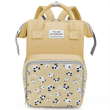 A beige mommy backpack with a patterned fabric featuring black and white panda faces.