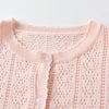 A light pink knitted cotton cardigan with a ribbed collar and button placket.
