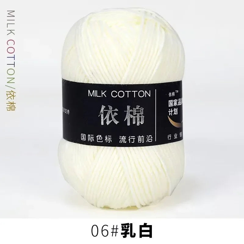A ball of white milk cotton yarn labeled 06# White.