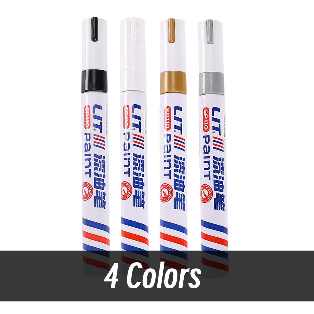 A set of eight permanent paint markers in various colors, including white and blue, standing upright.