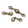 A set of antique brass magnetic clasps and connectors for jewelry making.