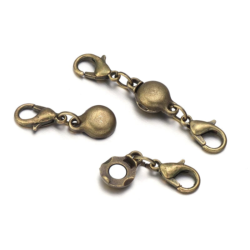 A set of antique brass magnetic clasps and connectors for jewelry making.