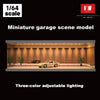 A miniature garage scene model featuring a car displayed under adjustable three-color lighting.