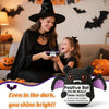 A smiling woman holds a knitted bat doll in a dark cloak with a young girl, set against a background of bats and pumpkins.