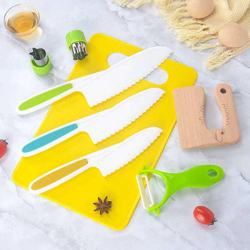 A set of safe plastic play knives and a yellow cutting board are displayed on a white surface.