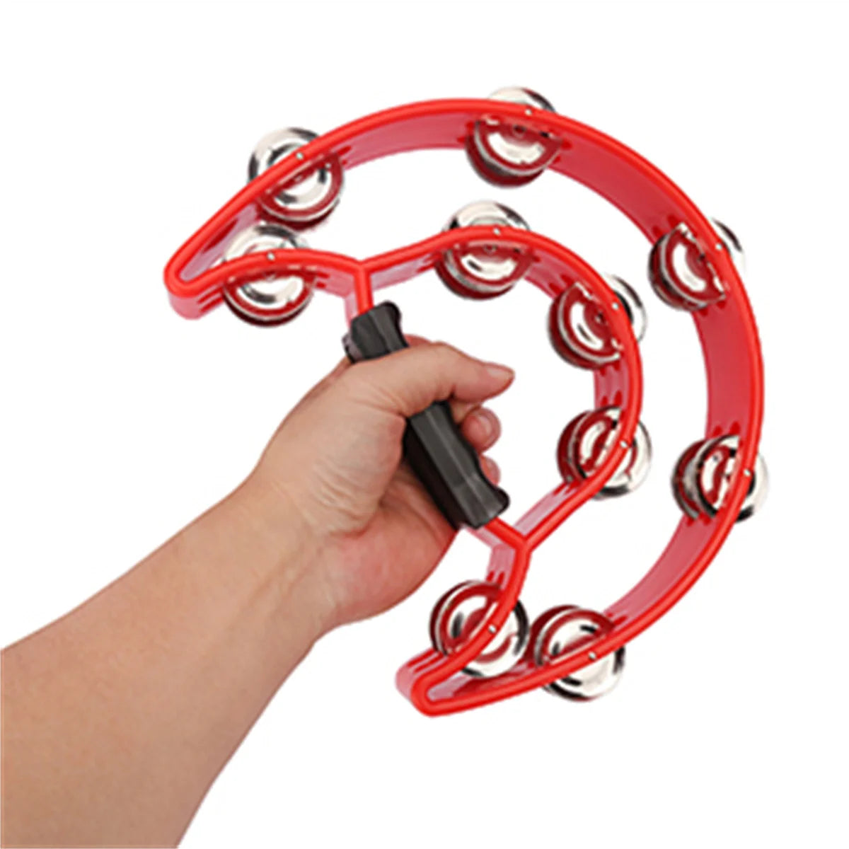 A hand is holding a red half-moon tambourine with silver jingles, demonstrating the instrument's shape.