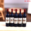 Five miniature resin wine bottles with corks and labels for a dollhouse set