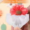 A hand holds a white silicone flower mold with a pink flower detail, showing an easy release design.