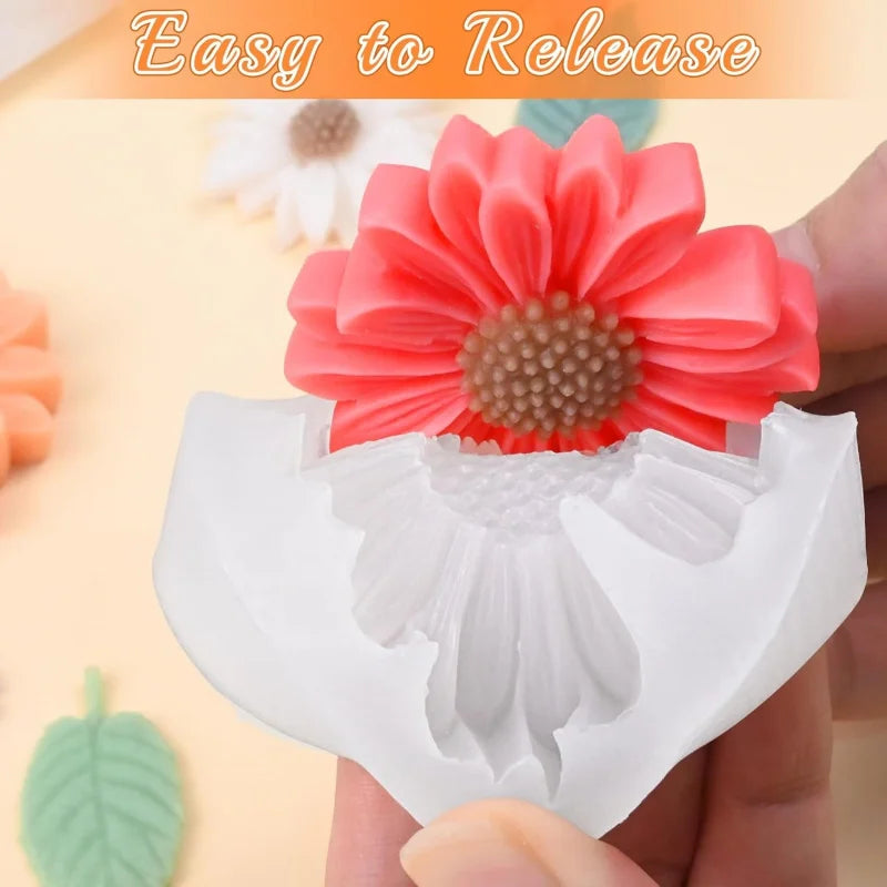 A hand holds a white silicone flower mold with a pink flower detail, showing an easy release design.