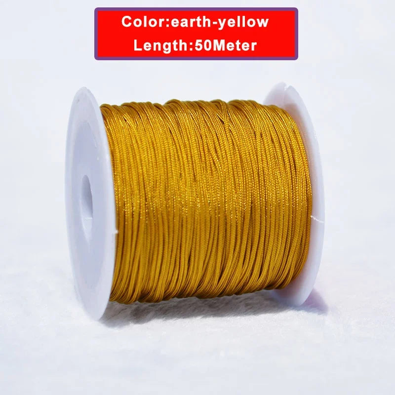 A spool of 50 meter earth-yellow nylon knotting cord for jewelry making.