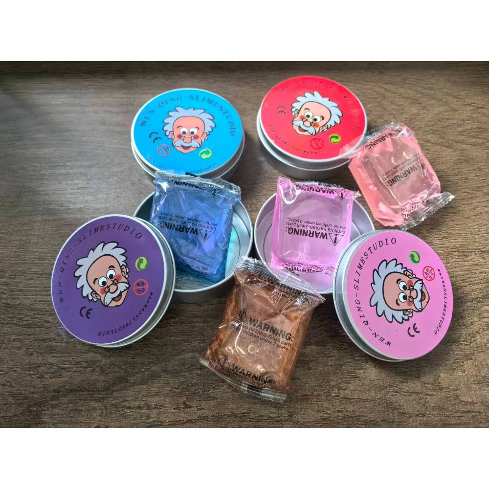 Various colorful sensory putty and stress relief toys in tins and plastic containers