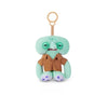 A cute green monster plush keychain with large eyes and brown clothing.