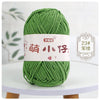 A ball of soft green chenille yarn with a white label featuring Chinese characters and a number tag.