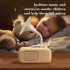 A white electronic device is positioned on a wooden surface, emitting sound into a white horn, with a baby sleeping nearby.