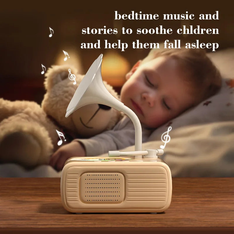 A white electronic device is positioned on a wooden surface, emitting sound into a white horn, with a baby sleeping nearby.