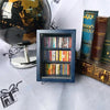 A handcrafted wooden miniature bookshelf ornament featuring small books and a decorative leather-bound book.