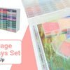 A set of diamond painting storage containers trays in various colors and a white organizer rack being used for storage.