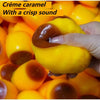 A hand squeezes a yellow, squishy pudding stress ball with a crisp sound.