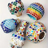 A collection of colorful mosaic glass tiles shaped into spherical and vase-like decorative objects.