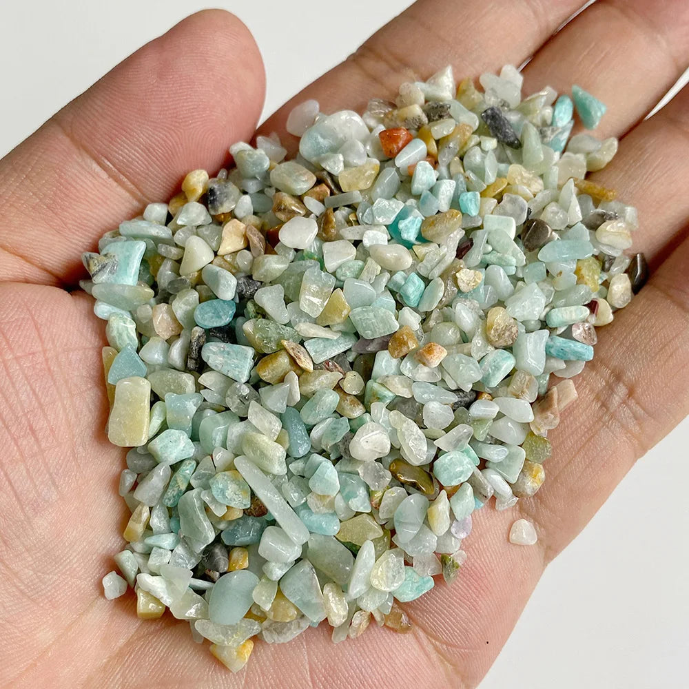 A handful of light blue and greenish-white natural tumbled stone chips for jewelry making