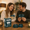 A couple laughing while looking at a box of Talking Hearts Couple Conversation Cards for date night and travel.