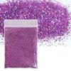 A small plastic bag filled with vibrant purple holographic glitter powder scattered on a white background.