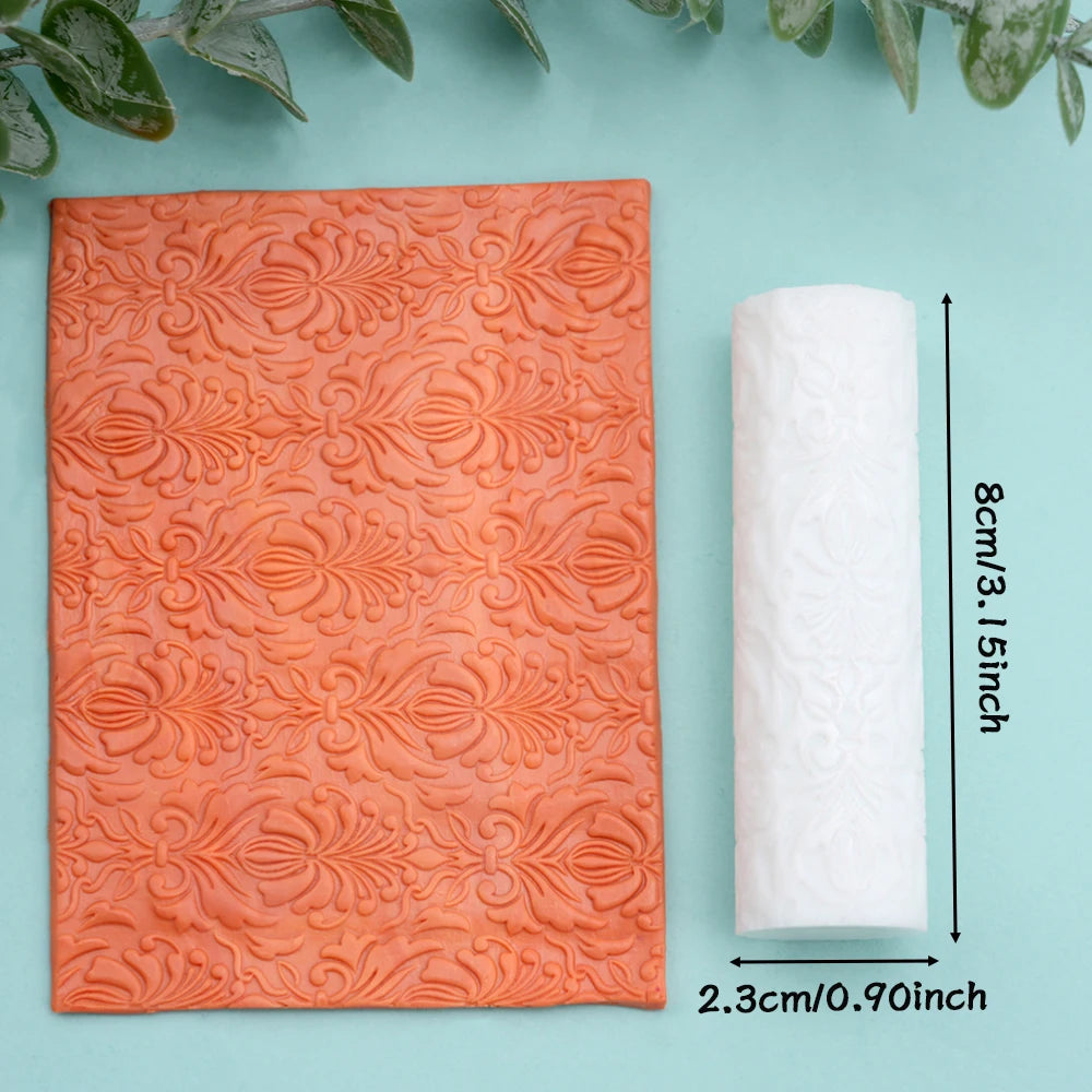 Orange floral texture roller for polymer clay and crafting shown next to a white roll.