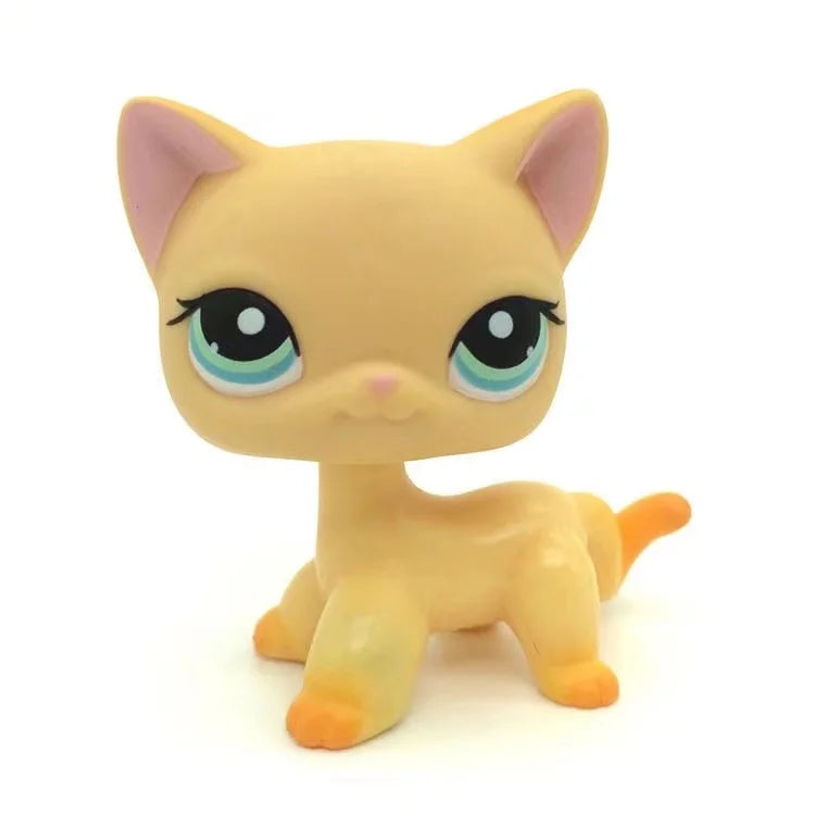 A yellow Littlest Pet Shop style standing dog figure with large eyes and pink inner ears.