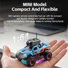 A hand holds a blue and orange 1:64 scale RC monster truck with an attached camera.