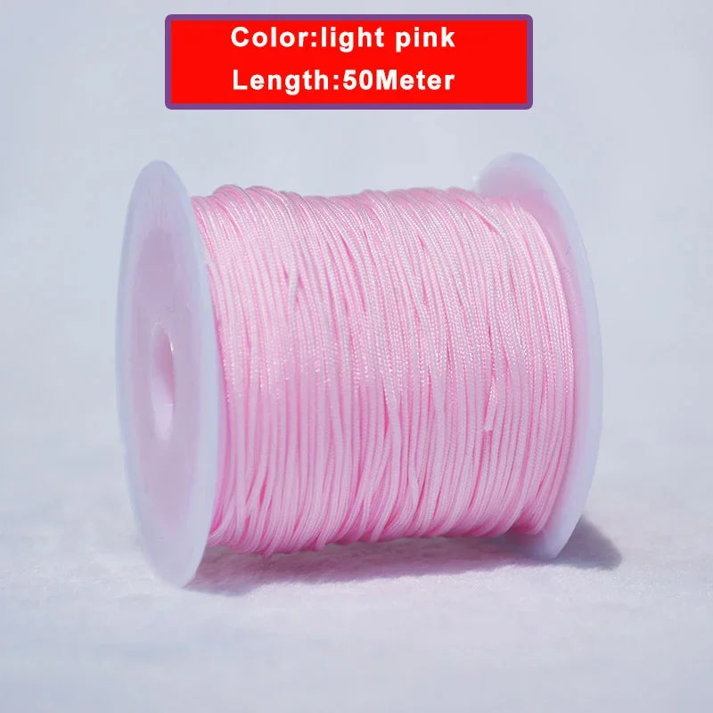 Pink nylon knotting cord on a spool with a label indicating the color is light pink and the length is 50 meters.