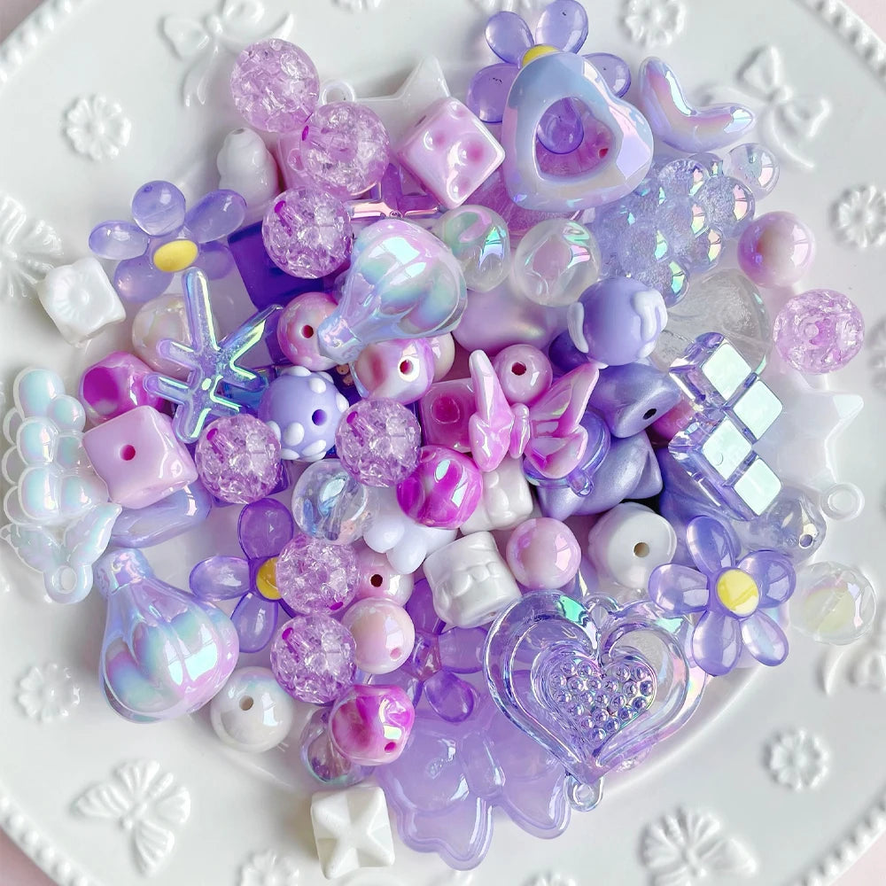 A collection of iridescent purple and pink acrylic bow and flower beads for DIY jewelry making