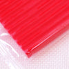 A close-up view of a bright red, smooth polymer clay modeling tool or block against a white background.