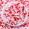 A bowl filled with red and pink polymer clay slice sprinkles for slime and DIY crafts