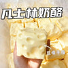 A hand holds a yellow squishy cheese cube stress ball with dimples, surrounded by other similar cubes.