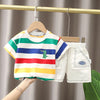 A boy's striped summer t-shirt and matching shorts set hanging on a wooden hanger.