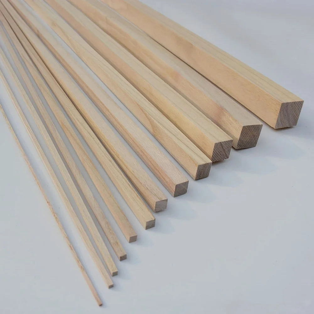 A row of natural solid wood strips, approximately 250mm long, laid diagonally on a white surface.