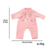 A pink baby bodysuit with a cute face design for a doll