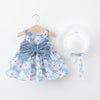 A light blue floral baby girl summer dress with a bow and a white woven sunhat