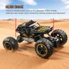 A black off-road RC car is driving across a sandy desert landscape.