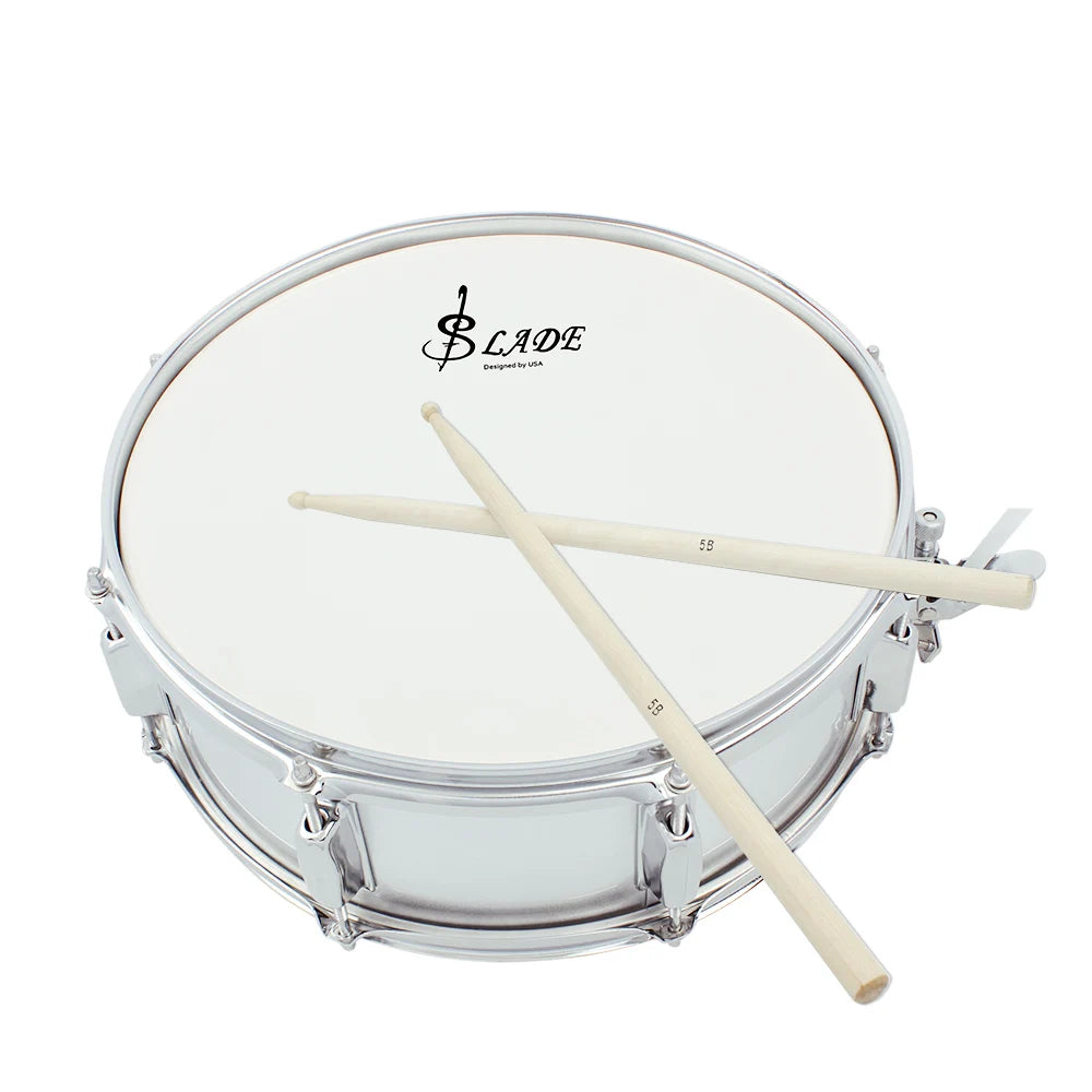 A silver drum with a white head and a set of light wood drumsticks resting across the top.