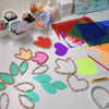 A collection of transparent colored PVC sheets, including hearts, leaves, and shapes, laid out on a white surface.