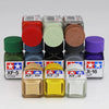 A set of acrylic paints in various colors and shades for model building and detailing, displayed in small plastic bottles.