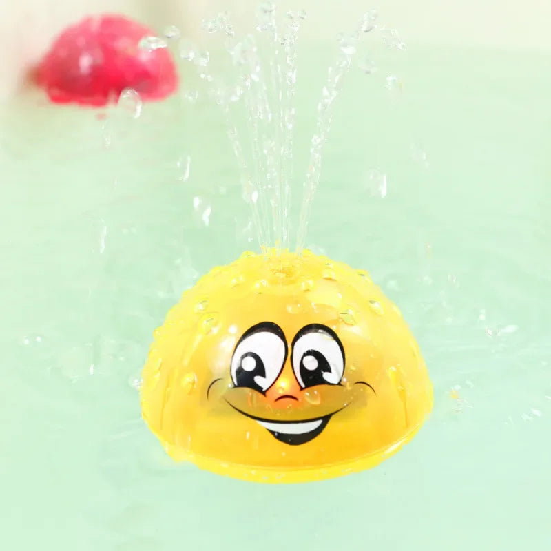 A yellow, smiling bath toy is being sprayed with water, with a red object visible in the background.