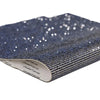 Blue sparkling rhinestone adhesive tape rolled up, showing a textured surface and brand markings.
