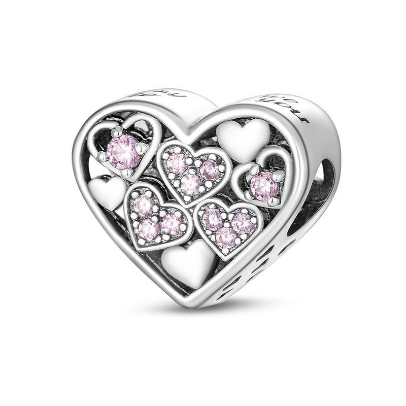 A silver heart charm bead featuring pink zircon stones, shaped like a heart.