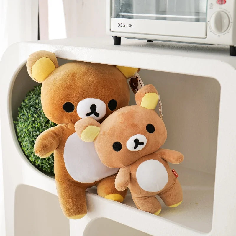 A brown Rilakkuma anime plush bear sitting inside a white plastic container.